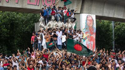 Protesters climb a public monument as they celebrate after getting the news of Prime Minister Sheikh Hasina's resignation, in Dhaka, Bangladesh, Monday, Aug. 5, 2024. (AP Photo / Rajib Dhar)