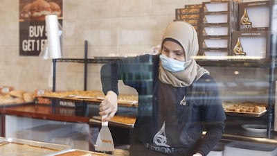 Dona Awada, an employee of Lebon Sweets, prepares traditional deserts in between serving customers on the first day of Ramadan on April 23, 2020 in Dearborn Heights, Michigan. Getty Images via AFP