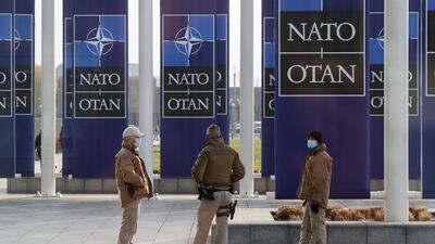 Security officers stand guard at the Alliance's headquarters in Brussels. EPA