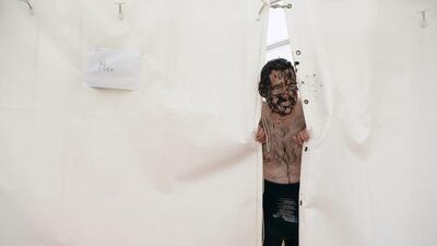 A male entrant looks out from the male changing area after taking part in the Irish Bog Snorkelling championship on Sunday. Charles McQuillan / Getty Images