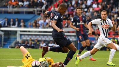 Angers' goalkeeper Ludovic Butelle makes a save in front of Mbappe. AFP