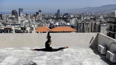 Sherazade Mami, a 28-year-old Tunisian professional dancer and performer at the Caracalla dance theatre and a teacher at the Caracalla dance school, practises while wearing a surgical mask on the roof of her apartment building in the suburb of Dekwaneh on the eastern outskirts of Lebanon's capital Beirut. AFP