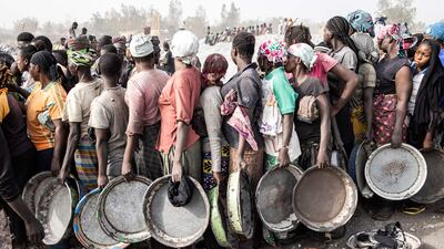 Women wait to collect their pay at Pissy Granite Mine in the centre of Ouagadougou, Burkina Faso, on January 29. AFP