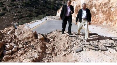 Salam Fayyad, right, the Palestinian Authority prime minister, inspects a section of the Freedom Road that was dug up by Israel. Jaafar Ashtiyeh / AFP
