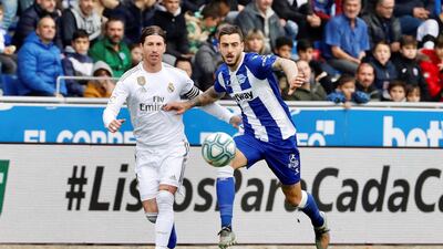 Real Madrid's Sergio Ramos (L) vies for the ball with Alaves' Joselu. EPA