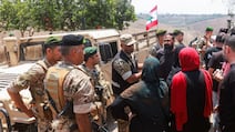 Residents attempt to enter Zawtar Al Gharbiyeh, as Lebanese army troops deploy in the area following the withdrawal of Israeli forces. Reuters