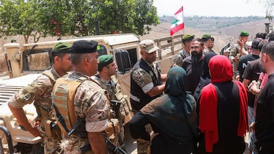 Residents attempt to enter Zawtar Al Gharbiyeh, as Lebanese army troops deploy in the area following the withdrawal of Israeli forces. Reuters