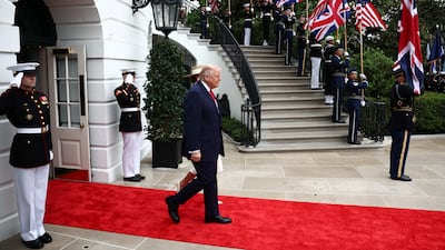 Mr Trump and his wife walk out to greet King Charles and Queen Camilla. PA