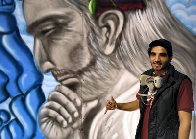 Abdul Malik Al Maskari with his mural at the Muscat Festival. Courtesy Ismael David