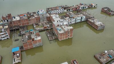 Floodwaters surround houses on the banks of the river Ganges, after heavy monsoon rains in Prayagraj, India, on Sunday. AP