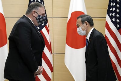 Michael Pompeo, US Secretary of State, left, greets with Yoshihide Suga, Japan's prime minister, exchange greetings on October 6, 2020. Bloomberg