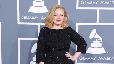 2012: Adele channels classic glamour in Giorgio Armani for the 54th annual Grammy Awards. FilmMagic
