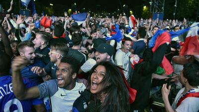France supporters cheer as they watch the Euro 2016 group A football match between France and Romania at the fan zone near the Eiffel tower in Paris on June 10, 2016. Alain Jocard / AFP