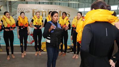 Tania Hettiaratchy lectures trainees on how to wear the life jackets for an emergency evacuation on water.