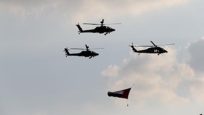 Helicopters withthe UAE flag fly over Adnec.