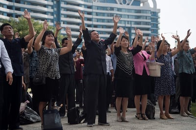 North Korean residents react as they watch the televised announcement on a big video screen on Mirae Scientists Street in Pyongyang that the country has successfully tested a hydrogen bomb on September 3, 2017. Kim Won-jin/AFP Photo