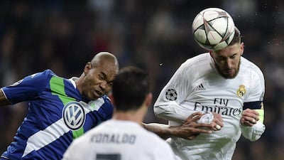 Real Madrid’s defender Sergio Ramos (R) vies with Wolfsburg’s Brazilian defender Naldo during the Champions League quarter-final second leg football match Real Madrid v Wolfsburg at the Santiago Bernabeu stadium in Madrid on April 12, 2016. AFP / JAVIER SORIANO