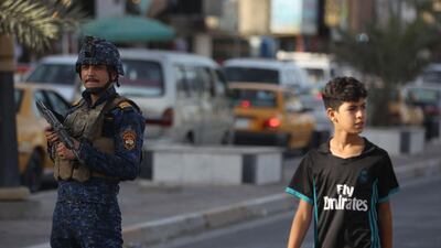 A members of the Iraqi Federal Police patrols the streets of Baghdad's Shula district, as part of enforced security measures taken by the government following the execution of convicted ISIS fighters on June 29, 2018. More than 800 children related to ISIS fighters are said to be Iraqi prisons. AFP / AHMAD AL-RUBAYE