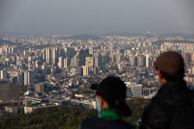 People look out at the Seoul skyline. Just 14 per cent of the population in South Korea has been fully vaccinated. Photo: Getty Images
