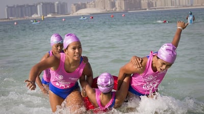 An all-female team from Aquaventure Waterpark competes at the UAE National Lifeguard Championships yesterday. Razan Alzayani / The National