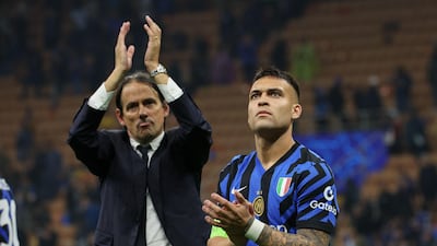 FC Inter Milan's forward Lautaro Martinez, right, and coach Simone Inzaghi salute the fans. EPA