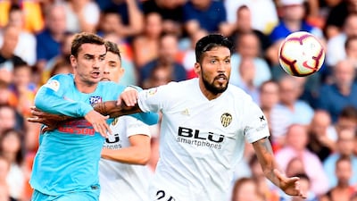 Ezequiel Garay, right, in action for Valencia against Barcelona. AFP
