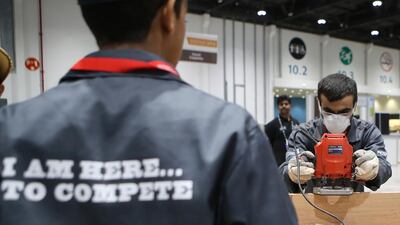 Taha Ali Al Hosani works on a joinery project during the EmiratesSkills competition in Abu Dhabi on Wednesday. Ravindranath K / The National
