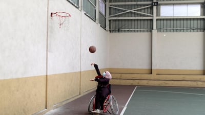 A Palestinian woman plays basketball during a local competition for people with disabilities in Gaza City on Thursday, January 21. Reuters