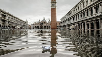 A paper boat floats in a flooded St Mark's Square in Venice last week. High tidal waters, peaking at 1.54 metres above sea level, returned to the Italian city. AP Photo