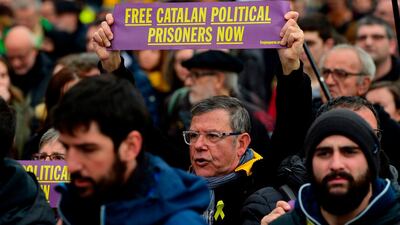A protester holds a sign calling for the release of jailed Catalan separatist leaders during a demonstration in Barcelona, Spain, on March 25, 2018. Lluis Gene / AFP Photo