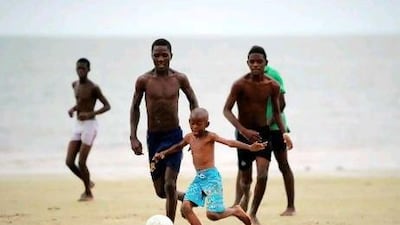 Children play football on the beach in Libreville. Despite interest in the sport in Africa, that has not shown itself in crowd numbers at the African Cup of Nations.