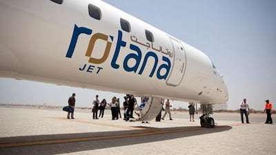 People disembark a Rotana Jet aircraft on the company's media flight to Sir Bani Yas Island last year. Now commuters will also be able to fly between Abu Dhabi and Dubai, with three return flights a week. Silvia Razgova / The National