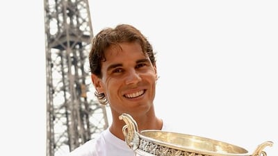 Rafael Nadal of Spain poses in front of the Eiffel Tower with his trophy after winning the French Open men's final at Roland Garros against Novak Djokovic of Serbia in Paris on June 9, 2014. Caroline Blumberg / EPA