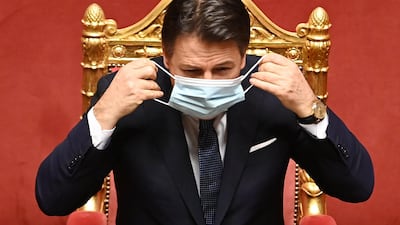 Italian Prime Minister Giuseppe Conte adjusts his face mask prior to an address at the Palazzo Madama in Rome, Italy. AFP