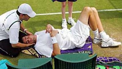Isner receives treatment as he plays Thiemo de Bakker of the Netherlands during their second round match.