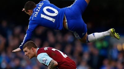Eden Hazard of Chelsea and Kieran Trippier of Burnley compete for the ball during their 1-1 Premier League draw at Stamford Bridge on Saturday. Julian Finney / Getty Images