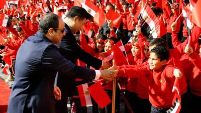 Egyptian president Abdel Fattah El Sisi and Chinese president Xi Jinping, shake hands with children at the Presidential Palace in Cairo on January 21, 2016. Mr Xi is on a two-day visit to the country - his first as Chinese president. Egyptian Presidency via AP