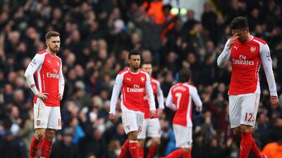 Aaron Ramsey, left, of Arsenal looks dejected with teammates during the Premier League match against Tottenham Hotspur at White Hart Lane on February 7, 2015, in London. Paul Gilham / Getty Images