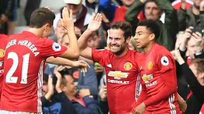 Manchester United midfielder Juan Mata, centre, is congratulated by his teammates after scoring against Leicester City at Old Trafford on Saturday, September 24, 2016. Anthony Delvin / AFP
