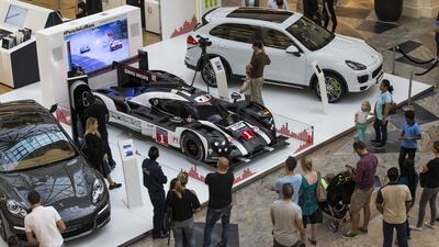 The Porsche 919 Hybrid, centre, which won at Le Mans 2016, flanked by the hybrid versions of the Panamera, left, and Cayenne, right. Courtesy Porsche