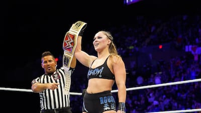 Ronda Rousey celebrates retaining her Raw Women's title at WWE Evolution. WWE