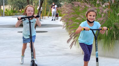 Tala, 7 and Amelia, 8, scooter around Al Fay Park on Reem Island
