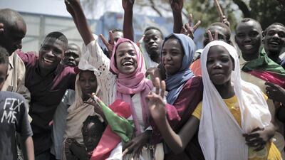 Sudanese women and men celebrate in Khartoum on August 17, 2019 after generals and protest leaders signed a transitional constitution to pave the way for civilian rule. AFP
