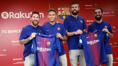 Gerard Pique, third from right, hopes Neymar, second right, will choose to stay at Barcelona. Eugene Hoshiko / AP Photo