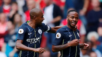 Raheem Sterling, right, celebrates with Fernandinho after scoring Manchester City's first goal against Arsenal. Reuters