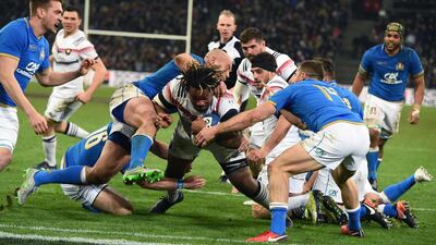 France's centre Mathieu Bastareaud, centre, dives and scores a try during the Six Nations match against Italy at the Stade Velodrome in Marseille. Boris Horvat / AFP