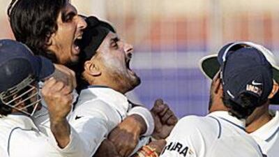 A jubilant Harbhajan Singh rejoices with his teammates after the fall of Mornie Morkel's wicket with minutes left for day's play to end.