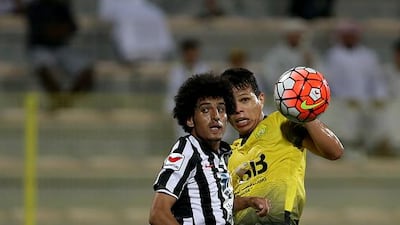 Al Wasl’s Fabio Lima, in yellow, and Al Jazira’s Saeed tussle for ball in the Arabian Gulf League on Friday night at Zabeel Stadium in Dubai. Ravindranath K / The National