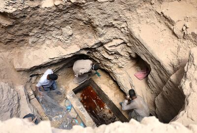 Archaeologists unearth coffin containing three mummies with sewage water and bones inside, in Alexandria, Egypt July 19, 2018. Reuters