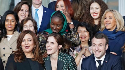Emma Watson, in a printed suit, with Wided Bouchamaoui and French President Emmanuel Macron, attends a meeting for gender equality at the Elysee Palace in Paris, France, on February 19, 2019. EPA